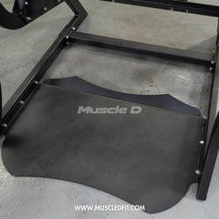 Muscle D Fitness Pro Strength Power Hack Squat machine with plate-loaded weight plates in a commercial gym setting.