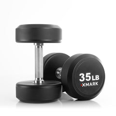 Pair of XMARK round commercial urethane dumbbells in various weights, showcasing durable free weights for strength training.