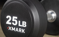 XMARK round commercial urethane dumbbells in 5-50 lb and 5-75 lb sets, showcasing durable coating and ergonomic design.