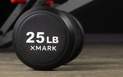 XMARK round commercial urethane dumbbells set, available in 5-50 lb and 5-75 lb, featuring durable rubber-coated free weights.
