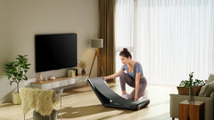 Foldable KingSmith WalkingPad A1 Pro treadmill for under desk use, shown in a compact, foldable position on a clean wooden floor.