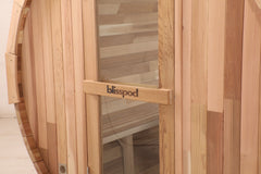 Zoppinh Blisspod Prague outdoor steam barrel sauna made of Canadian Red Cedar, featuring a compact design with a glass door and wooden exterior.