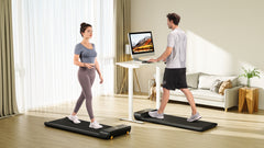 Foldable KingSmith WalkingPad A1 Pro treadmill for under desk use, showing compact design and control panel in a home office setting.