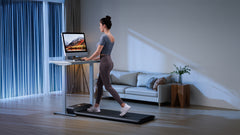 Foldable Kingsmith WalkingPad A1 Pro treadmill for under desk use, shown folded and in use in a home office setting.