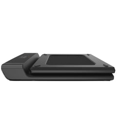 Foldable KingSmith WalkingPad A1 Pro treadmill for under desk use, shown folded with sleek black design on a wooden floor.