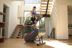 Pro 6 Aspen StairMill household stairclimber showing a compact, sturdy design with handrails and step mechanism for at-home use.