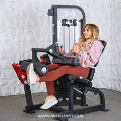 Muscle D Fitness Classic V2 selectorized leg extension and seated leg curl machine with adjustable pads and sturdy frame.