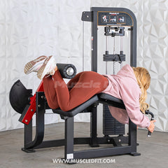 Muscle D Fitness Classic V2 Selectorized Prone Leg Curl machine for targeting hamstrings in a commercial gym setting