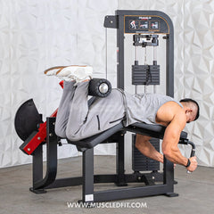 Muscle D Fitness Classic V2 Selectorized Prone Leg Curl machine for targeted hamstring exercises in a commercial gym setting
