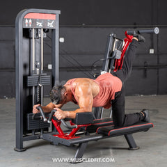 Muscle D Fitness Classic V2 Selectorized Glute Kick Machine for strength training in commercial gyms, featuring adjustable seat and padded support.
