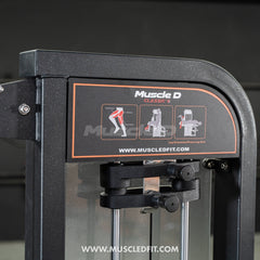 Muscle D Fitness Classic V2 Leg Extension and Prone Leg Curl combo selectorized machine with padded supports and adjustable settings.