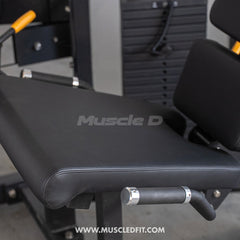 Muscle D Fitness Classic V2 selectorized leg extension machine with padded seat and adjustable leg pad for strength training.