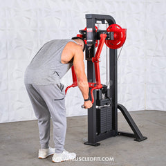 Muscle D Fitness Classic V2 Selectorized Standing Lateral Raise Machine with padded arm supports and weight stack in a gym setting.