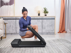 Foldable KingSmith WalkingPad A1 Pro treadmill for under desk use, shown in compact, folded position on a clean floor.