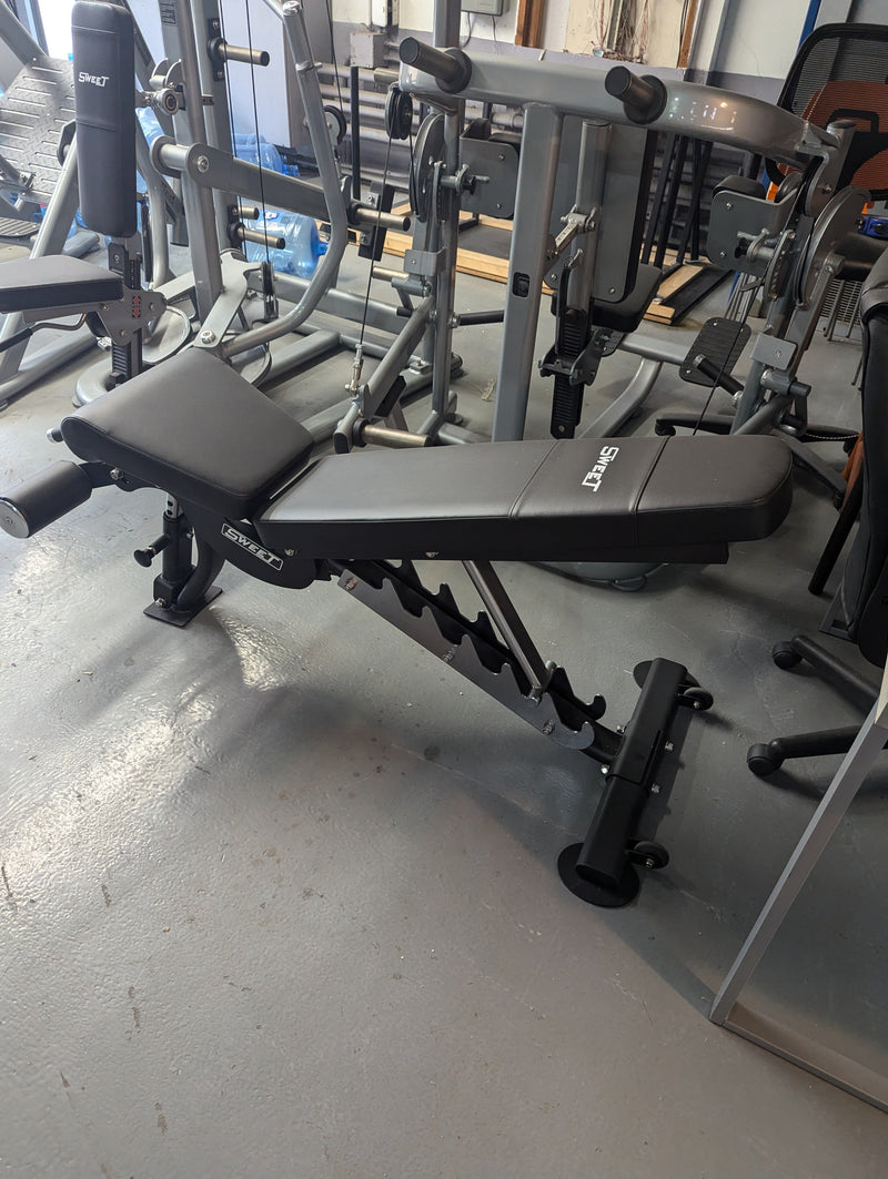 Muscle D Fitness Sweet Flat Incline Decline Adjustable Bench with padded surface and adjustable settings for versatile workouts.
