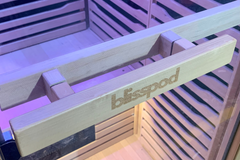 Two people enjoying the Zoppinh Blisspod Helsinki full spectrum indoor sauna in a modern, well-lit home setting.