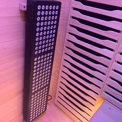 Two-person Blisspod Helsinki full spectrum indoor sauna by Zoppinh, featuring wooden interior and control panel.