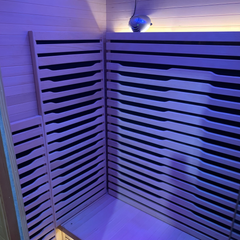 Two-person Blisspod Helsinki full spectrum indoor sauna by Zoppinh, with wooden interior and digital control panel.