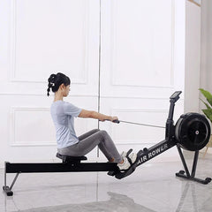 Water rowing machine by 24 Hour Sport with wooden finish, adjustable footrests, and digital display for at-home fitness workouts.