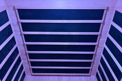 Zoppinh Finnmark FD-3 full spectrum infrared sauna for four people, with wooden benches and control panel inside a modern home setting.