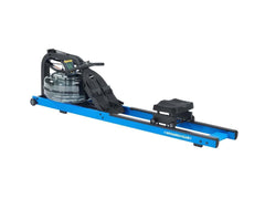 First Degree Fitness Monarch Club V Fluid Rower rowing machine with adjustable resistance and digital display in a home gym setting.