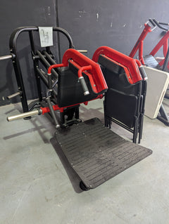 Muscle D Fitness Pro Strength Plate Loaded Hack Squat machine with adjustable safety stops and weight plates for strength training.