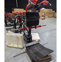 Plate loaded hack squat machine by Muscle D Fitness with sturdy frame and weight plates for strength training.