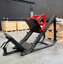 Muscle D Fitness heavy-duty plate loaded leg press machine with padded seat and weight plates, designed for strength training.
