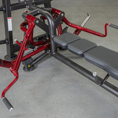 Muscle D Fitness Power Leverage V2 Lying Pec Fly plate-loaded exercise machine with padded seat and arm pads for chest workouts.