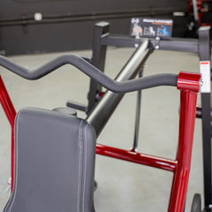 Muscle D Fitness Power Leverage V2 Overhead Triceps plate-loaded exercise machine with padded seat and adjustable arm support.