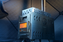 North Shore Sauna XL wood stove inside a sauna tent, showcasing the compact design and heating element for sauna use.