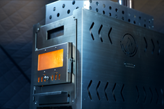 North Shore Sauna XL wood stove inside a portable sauna tent, showcasing the heating element and cozy interior setup.