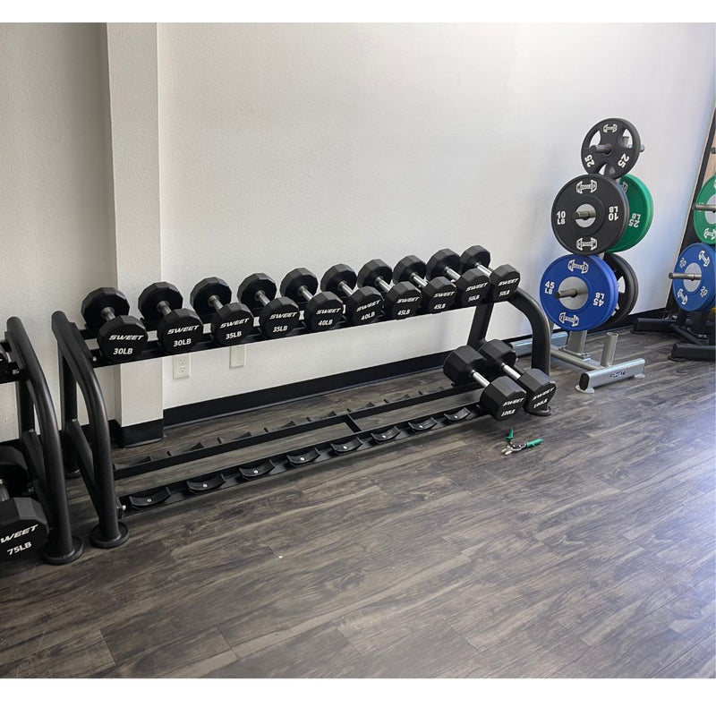Muscle D Fitness sweet 2-tier dumbbell rack holding various dumbbells in a gym setting