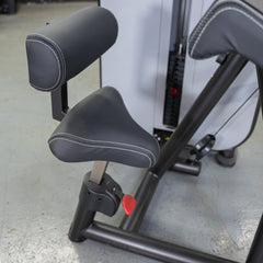 Muscle D Fitness Vogue Biceps Triceps Combo selectorized machine with padded arm supports and weight stacks for strength training.