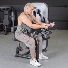 Muscle D Fitness Vogue Biceps Triceps Combo selectorized machine for arm strength training, featuring adjustable handles and padded seat.