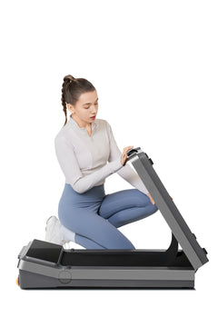 Walkingpad Z3 Kingsmith treadmill shown on a sleek black surface, featuring a compact design with a digital display and safety handles.