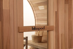 Zoppinh Blisspod Prague outdoor steam barrel sauna made of Canadian Red Cedar with glass door and seating inside.