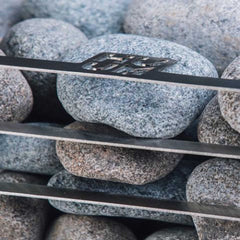 SAKSBY WHOLESALE Huum Cliff Mini 4 electric sauna heater with 3.5KW power, shown in use with stones inside a sauna.