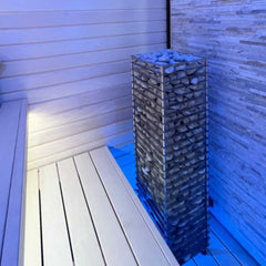 SAKSBY WHOLESALE Huum Cliff Slim Electric Sauna Heater in stainless steel with blue light and two prop blocks, designed for home saunas.