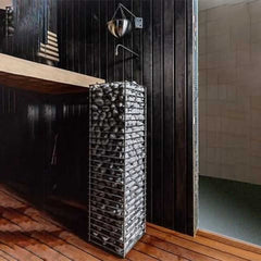 SAKSBY WHOLESALE Huum Cliff Slim electric stainless steel sauna heater with two prop blocks, front-left view.