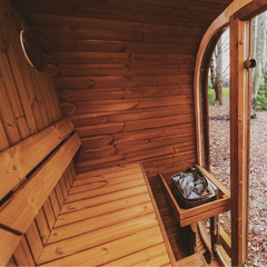 Patio Elegance Mande MW20 Outdoor ThermoWood Sauna placed in a backyard with wooden decking and lush greenery.