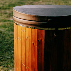 Close-up of a fully-assembled SAKSBY WHOLESALE Premium 1-Person ThermoWood Cold Plunge Tub with cover, showcasing its wooden design and lid.
