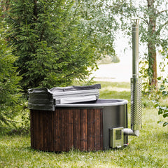 Front right view of a fully assembled four-person ThermoWood hot tub by SAKSBY WHOLESALE on grass, showcasing wood-fired design.