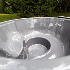 Inside view of SAKSBY WHOLESALE premium 4-person fully-assembled ThermoWood wood-fired hot tub showing seating and interior details.