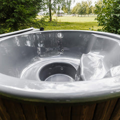 Inside view of SAKSBY WHOLESALE premium 4-person ThermoWood wood-fired hot tub showing wood seats and interior design.