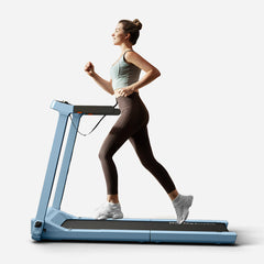 Blue WalkingPad Denise Austin 2.0 foldable treadmill with digital display and safety handrails for home exercise.