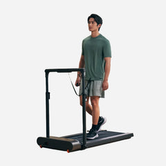 WalkingPad R3 Hybrid foldable walking treadmill with digital display and safety handrails in a home gym setting