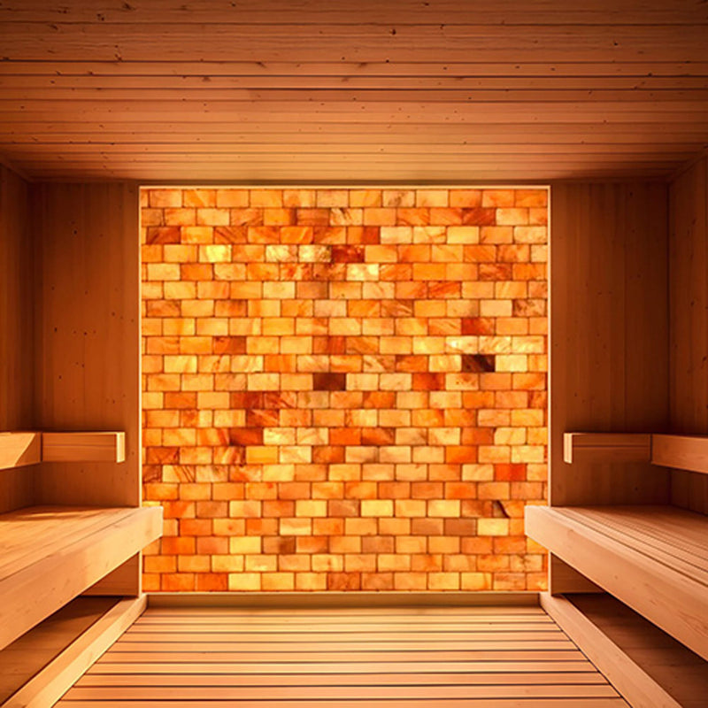 Prosaunas Himalayan Salt Sauna Wall Kit by SAKSBY WHOLESALE featuring customizable salt panels and amber LED lighting for sauna ambiance.