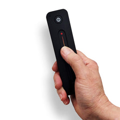 Hand holding remote control for Prosaunas Himalayan Salt Sauna Wall Kit by SAKSBY WHOLESALE, showcasing customizable sauna wall setup.