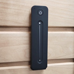 Prosaunas Himalayan Salt Sauna Wall Kit by SAKSBY WHOLESALE with remote control mounted on sauna wall for customizable salt therapy.